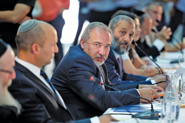 Israeli Defense Minister Avigdor Lieberman, center, a special cabinet meeting to mark Jerusalem Day in Ein Lavan, on the outskirts of Jerusalem, Thursday, June 2, 2016. (Abir Sultan/Pool Photo via AP)