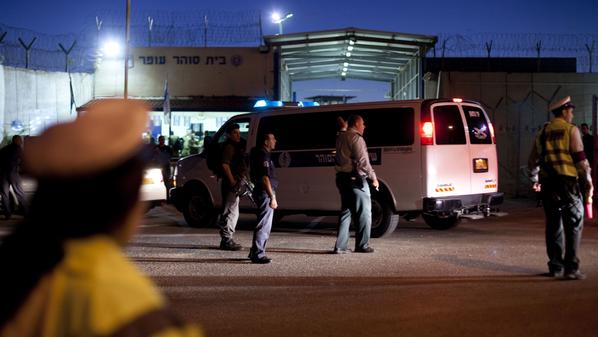 OFER PRISON, ISRAEL - OCTOBER 18: (ISRAEL OUT) A convoy of Israeli Prison Service buses carrying Palestinians prisoners who are to be exchanged for captive Israel Defense Forces soldier Gilad Shalit, arrive at Israel?s Ofer prison, between Jerusalem and Ramallah, on October 18, 2011. A high-profile prisoner swap which will see the release of captive Israel Defense Forces soldier Gilad Shalit began before dawn on Tuesday. Shalit is to be freed after more than 5 years of captivity in Gaza in an exchange deal which will see the release of 477 Palestinian prisoners in an initial deal with another 550 to freed after the return of Shalit. (Photo by David Vaaknin/Getty Images)