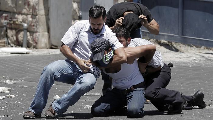 Israeli undercover policemen arrest a Palestinian during clashes following traditional Friday prayers near the Old City in East Jerusalem on July 25, 2014. Israeli security forces are on heightened alert after a Palestinian man was shot dead during a huge protest in the West Bank against Israel's military offensive in Gaza. Palestinian factions in the West Bank declared a "Day of Rage" after the previous night's clashes around the West Bank and in some sectors of Israeli-annexed east Jerusalem. AFP PHOTO / AHMAD GHARABLI (Photo credit should read AHMAD GHARABLI/AFP/Getty Images)