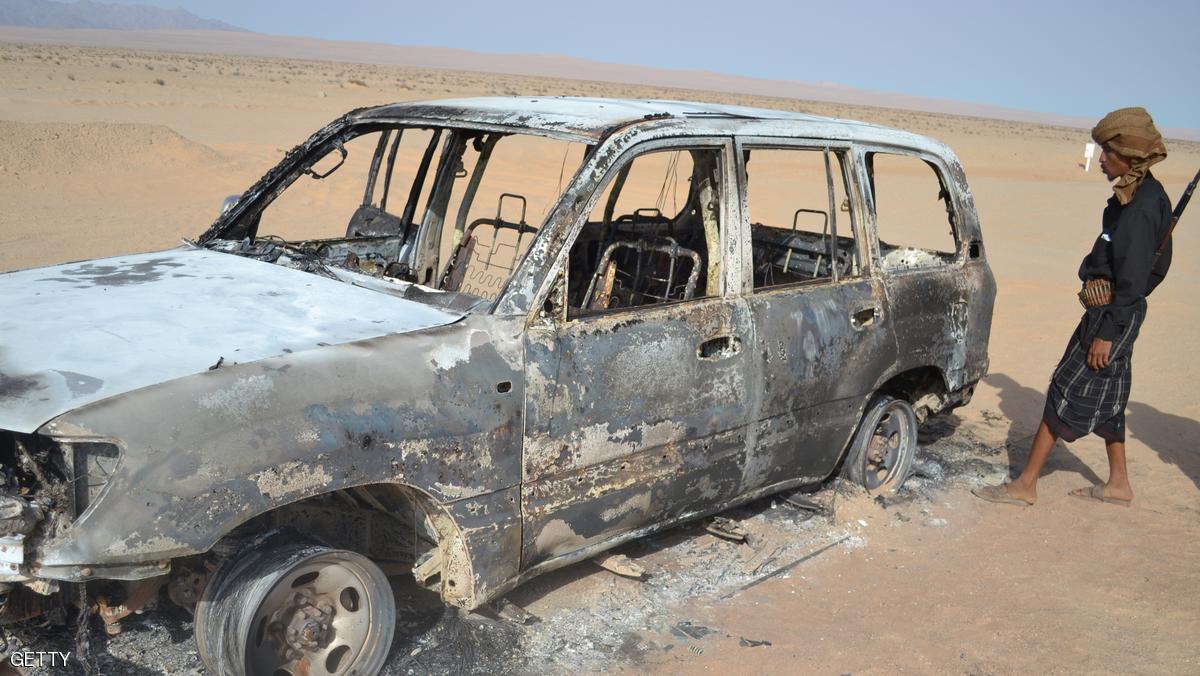 An armed Yemeni man walks towards a burnt out car at the site where a gas pipeline was blown up near Mayfaa in southeast Yemen's Shabwa province on May 14, 2012. "Al-Qaeda blew up the pipeline in response to the raids that targeted it" over the past week, a Yemeni official in the restive region said. AFP PHOTO/STR (Photo credit should read -/AFP/GettyImages)