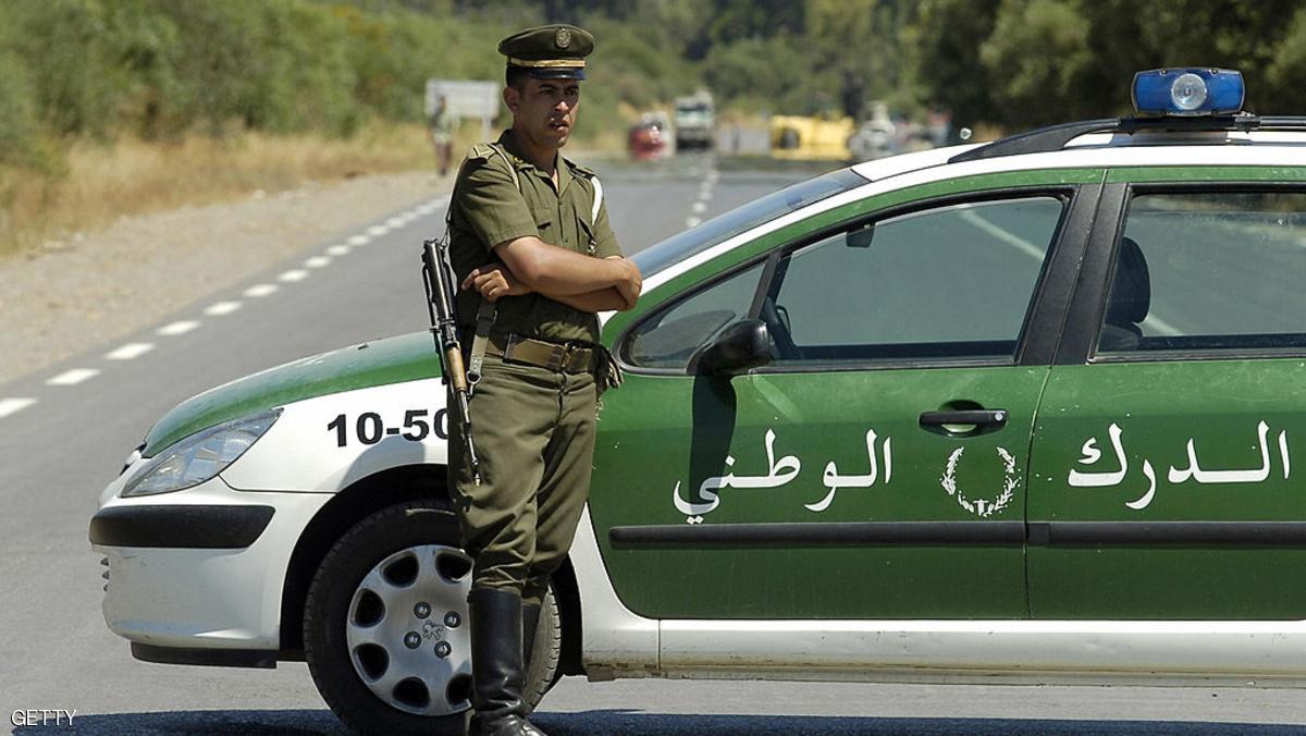 Lakhdaria, ALGERIA: An Algerian policeman stands guard as security forces block the road to Lakhdaria, 70 kilometres (45 miles) southeast of Algiers, where a suicide bomber rammed an explosives-packed truck into an Algerian barracks 11 July 2007, killing eight soldiers, according to security sources. The attack took place just a few hours before a major African sporting event started in the capital. A major security operation was launched around Lakhdaria, in parallel to the huge precautions taken for the All-Africa Games which involve 8,000 athletes from more than 20 countries. AFP PHOTO/FETHI BELAID (Photo credit should read FETHI BELAID/AFP/Getty Images)