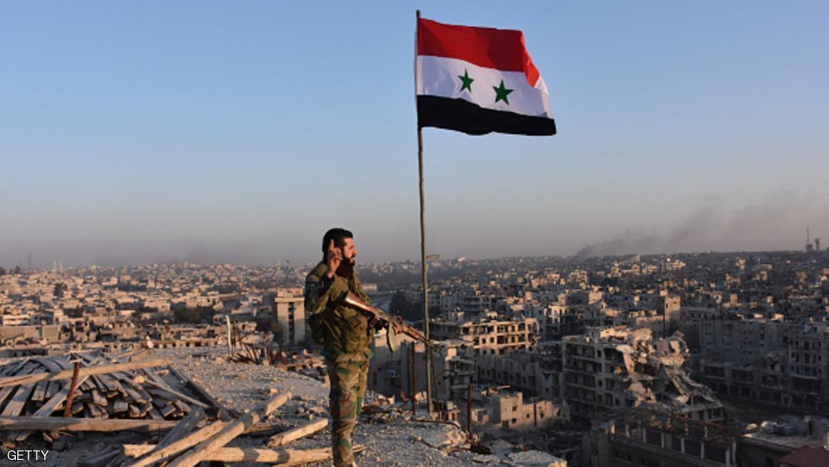 TOPSHOT - Syrian pro-government forces stand on top of a building overlooking Aleppo in the city's Bustan al-Basha neighbourhood on November 28, 2016, during their assault to retake the entire northern city from rebel fighters.
In a major breakthrough in the push to retake the whole city, regime forces captured six rebel-held districts of eastern Aleppo over the weekend, including Masaken Hanano, the biggest of those in eastern Aleppo. / AFP / GEORGE OURFALIAN (Photo credit should read GEORGE OURFALIAN/AFP/Getty Images)