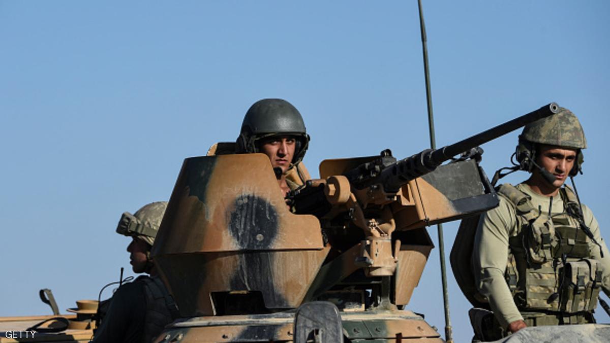 TOPSHOT - Turkish soldiers stand in a Turkish army tank driving back to Turkey from the Syrian-Turkish border town of Jarabulus on September 2, 2016 in the Turkish-Syrian border town of Karkamis. Turkish military experts on September 1, 2016 cleared mines from the area of the Syrian town of Jarabulus captured from jihadists last week, using controlled explosions that sent clouds of dust and smoke into the sky, an AFP photographer said. Pro-Ankara Syrian rebels, backed by Turkish aviation and tanks, took Jarabulus from Islamic State (IS) fighters in a lightning operation and now enjoy full control of the town. / AFP / BULENT KILIC (Photo credit should read BULENT KILIC/AFP/Getty Images)