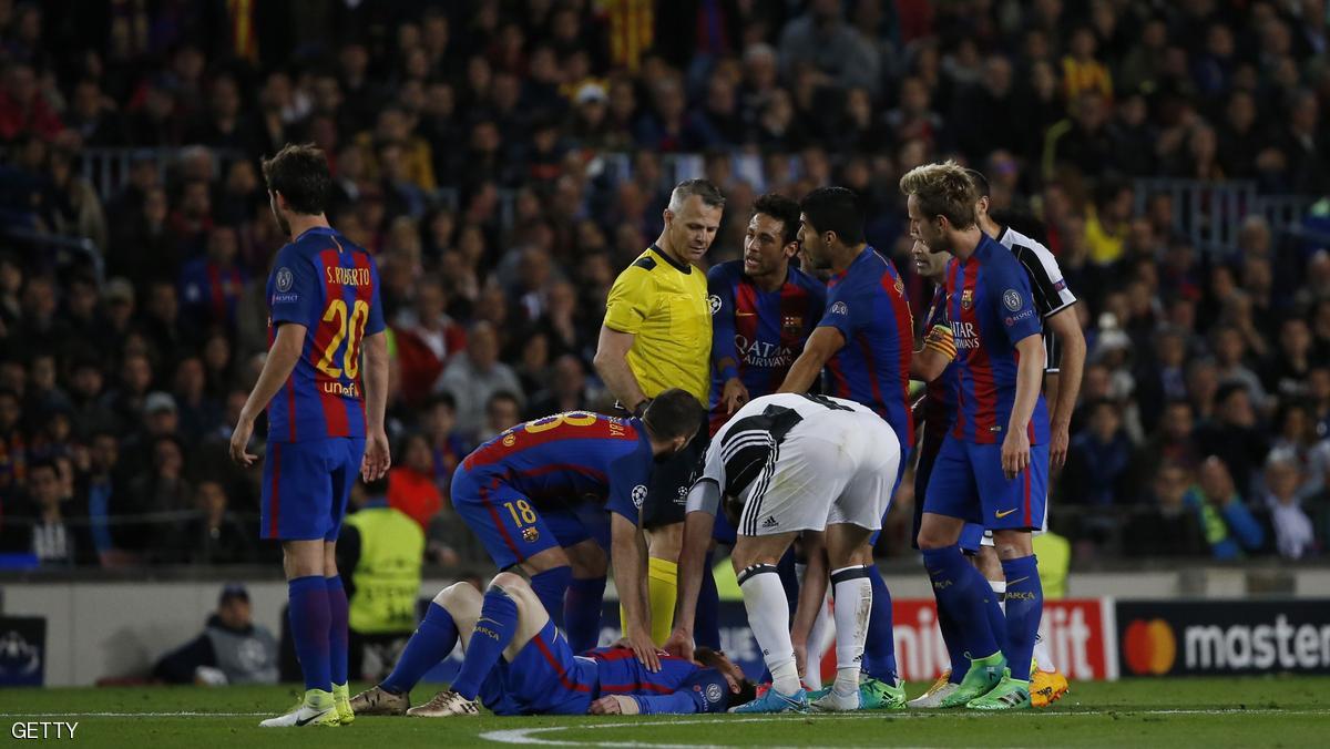 Barcelona players gather around Barcelona's Argentinian forward Lionel Messi (DOWN) after a clash during the UEFA Champions League quarter-final second leg football match FC Barcelona vs Juventus at the Camp Nou stadium in Barcelona on April 19, 2017. / AFP PHOTO / Marco BERTORELLO (Photo credit should read MARCO BERTORELLO/AFP/Getty Images)