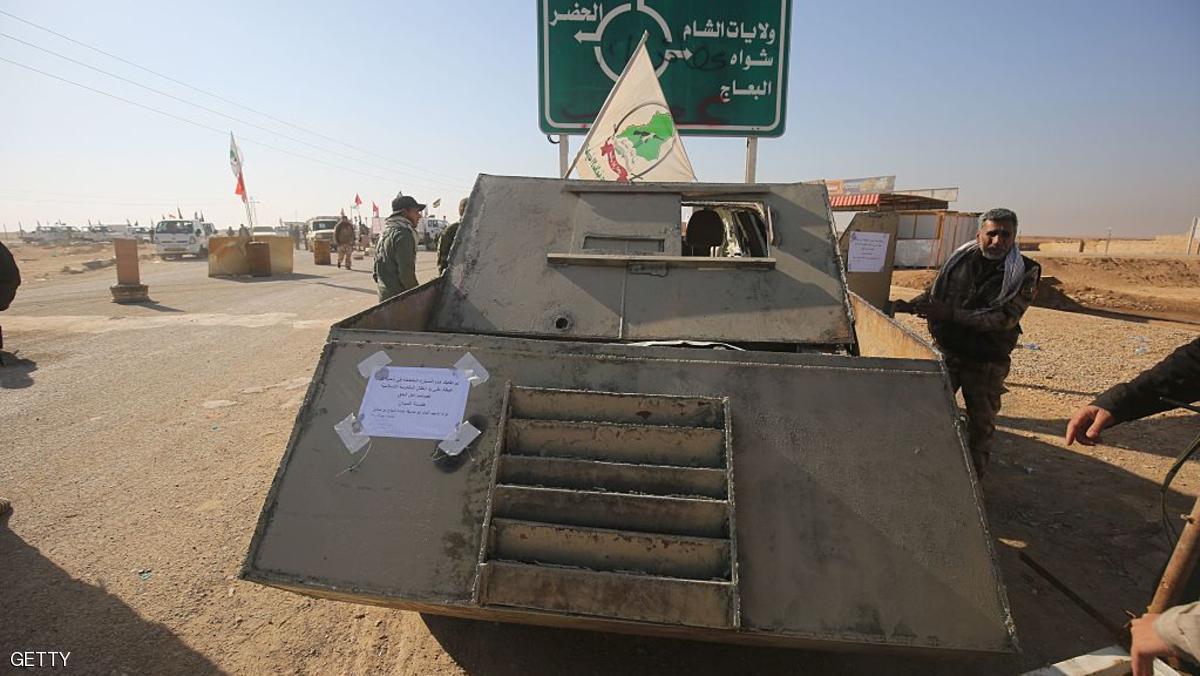 An Iraqi Shiite fighter from the Hashed al-Shaabi (Popular Mobilisation) paramilitary forces walks past a vehicle used by Islamic State (IS) figthers for ram-raids on December 10, 2016 in the town of Tal Abtah, south of Tal Afar, after Iraqi forces retook the area during a broad offencive to retake the city of Mosul from IS jihadists.
Hashed al-Shaabi (Popular Mobilisation) paramilitary forces have made progress in recent weeks on a western front targeting Tal Afar town on the road linking Mosul to Syria. On December 8, 2016, the paramilitary forces were clearing Tal Abtah of bombs and booby traps after a fierce, days-long fight to retake it. / AFP / AHMAD AL-RUBAYE (Photo credit should read AHMAD AL-RUBAYE/AFP/Getty Images)