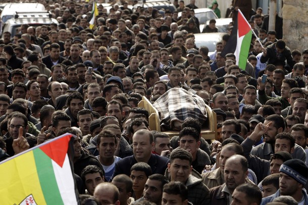 Palestinian men carry the body of Amr Qawasme during his funeral after he was killed by Israeli troops in the West Bank city of Hebron January 7, 2011. The Israeli troops killed the 65-year-old Palestinian in his bedroom on Friday during a pre-dawn raid to seize a Hamas suspect who lived in the same building in what the army admitted was a mistake. REUTERS/Ammar Awad (WEST BANK - Tags: POLITICS CIVIL UNREST MILITARY)