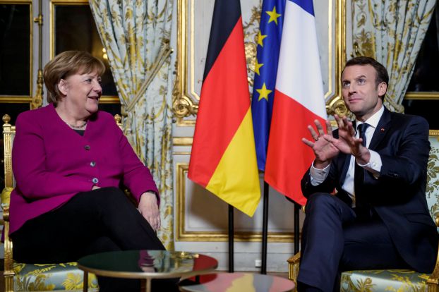 French President Emmanuel Macron and German Chancellor Angela Merkel react during their meeting at the Elysee Palace in Paris, France, January 19, 2018. REUTERS/Christophe Petit Tesson/Pool