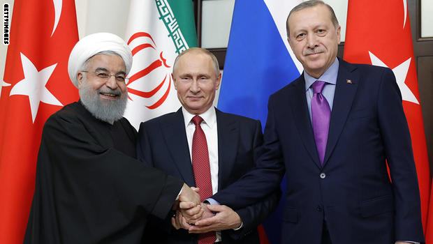 Russian President Vladimir Putin (C), Turkish President Recep Tayyip Erdogan (R) and Iranian President Hassan Rouhani pose during a trilateral meeting on Syria in Sochi on November 22, 2017. / AFP PHOTO / SPUTNIK / Mikhail METZEL (Photo credit should read MIKHAIL METZEL/AFP/Getty Images)