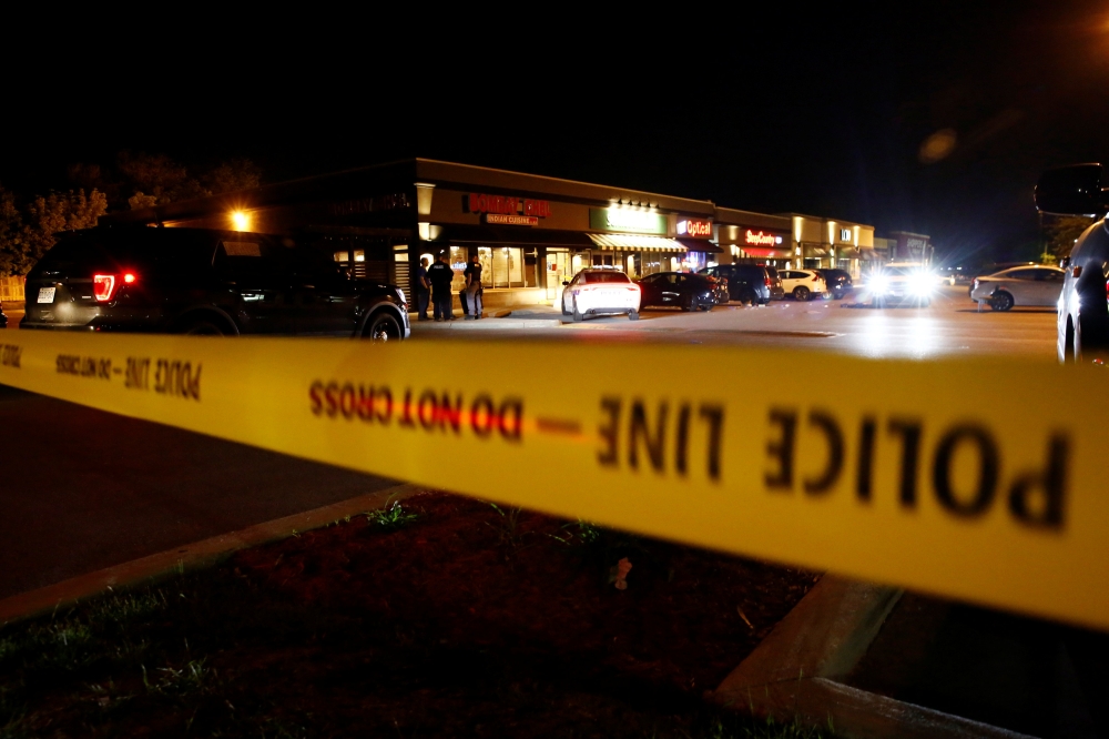 Police officers stand in front of the Bombay Bhel restaurant, where two unidentified men set off a bomb late Thursday night, wounding more than a dozen people, in Mississauga, Ontario, Canada May 25, 2018. REUTERS/Mark Blinch