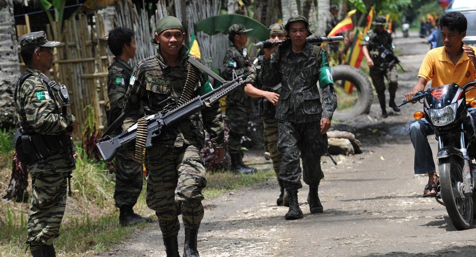 In this photo taken on September 5, 2011 Moro Islamic Liberation Front (MILF) rebels patrolling inside camp Darapanan in Sultan Kudarat province, in southern island of Mindanao. The Philippine government and Muslim rebels said January 25, 2014, they had cleared the last hurdle in long-running peace negotiations, paving the way to end a deadly decades-old insurgency in the country's south. AFP PHOTO/TED ALJIBE (Photo credit should read TED ALJIBE/AFP/Getty Images)