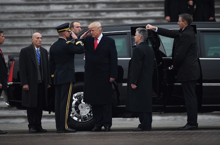 US President Donald Trump salutes after reviewing the troops as he departs the Capitol following his inauguration, on January 20, 2017 in Washington, DC. Donald Trump was sworn in as the 45th president of the United States Friday -- ushering in a new political era that has been cheered and feared in equal measure. / AFP PHOTO / POOL AND GETTY IMAGES NORTH AMERICA / Robyn BECK