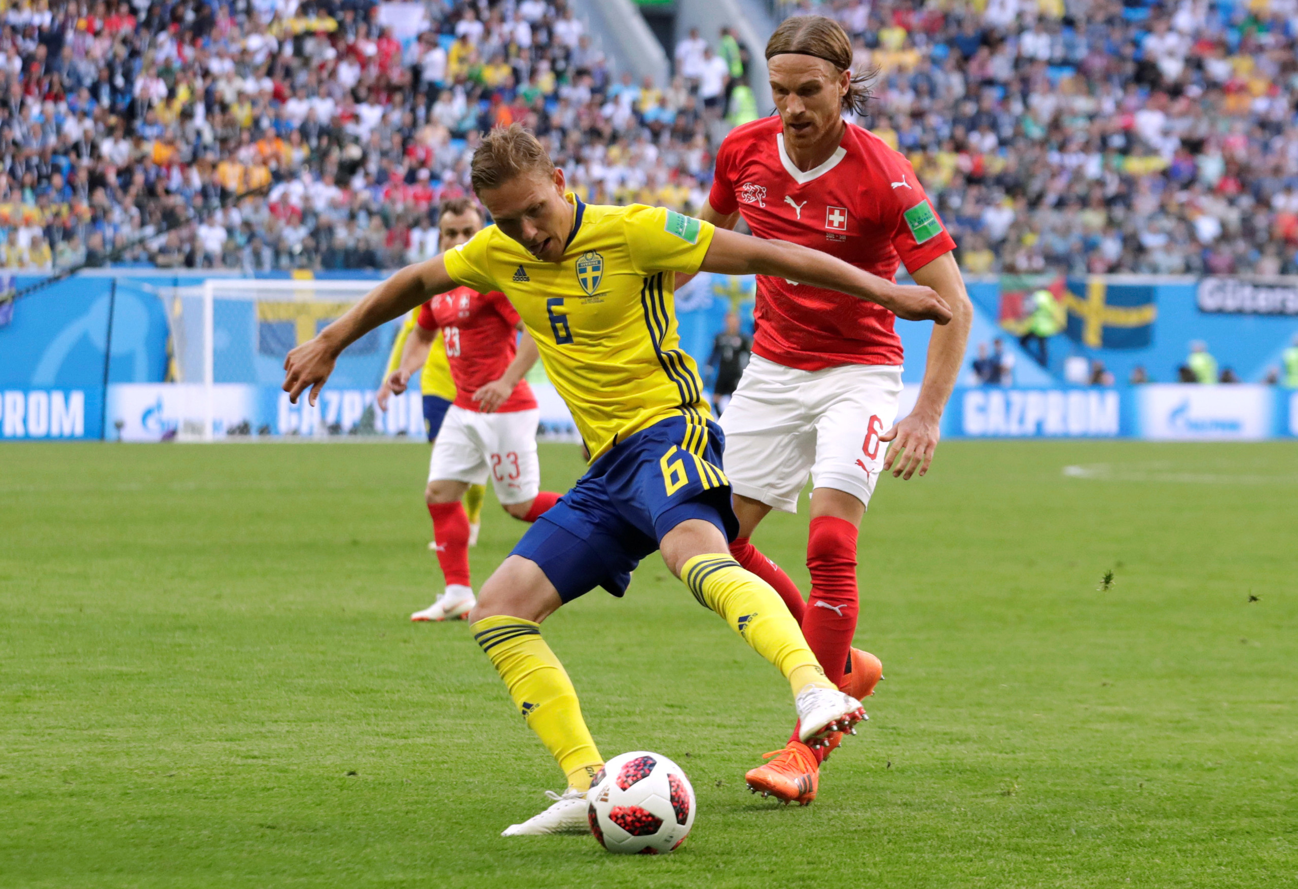 Soccer Football - World Cup - Round of 16 - Sweden vs Switzerland - Saint Petersburg Stadium, Saint Petersburg, Russia - July 3, 2018 Sweden's Martin Olsson and Switzerland's Michael Lang in action REUTERS/Henry Romero