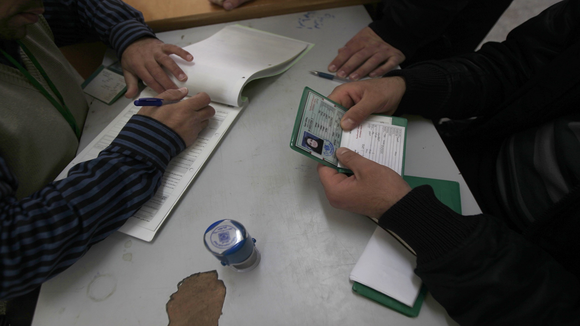 An electoral commission official registers Palestinians at a registration office in Rafah town in the southern Gaza Strip on February 18, 2013. Palestinian electoral officials extended for two additional days the process of updating voter rolls in the West Bank and Gaza After a week of beginning registration in a vital step towards eventual elections. AFP PHOTO/ SAID KHATIB (Photo credit should read SAID KHATIB/AFP/Getty Images)