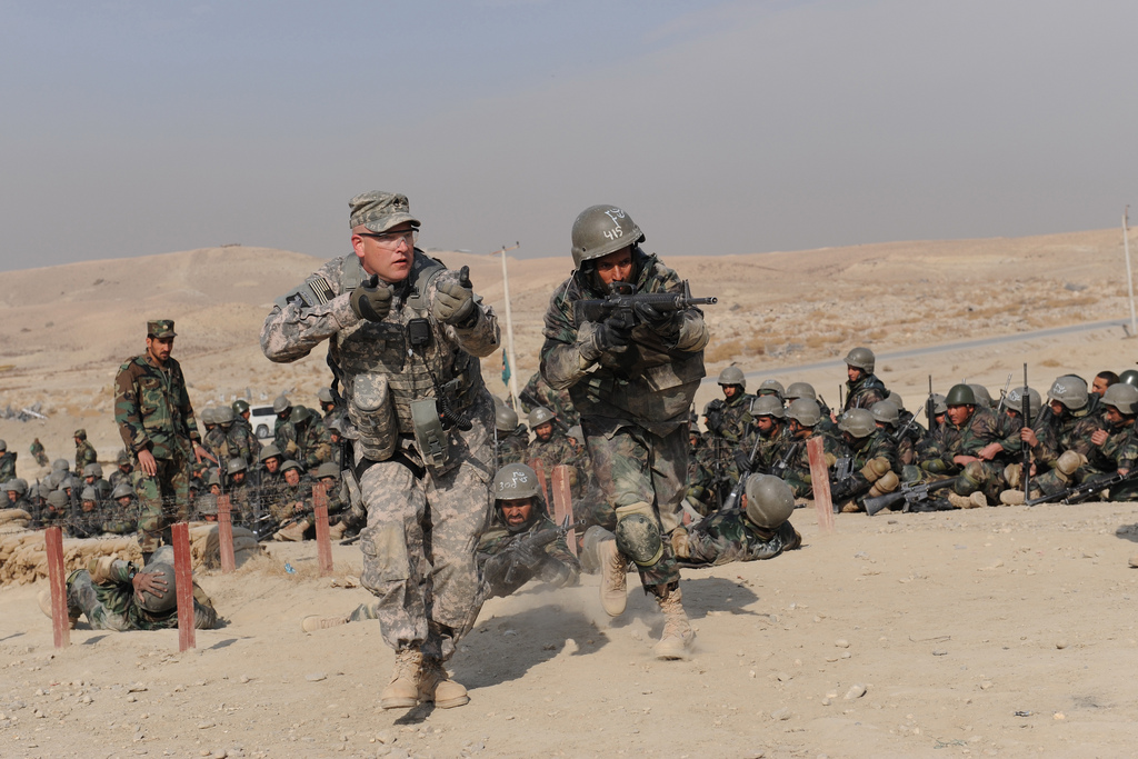 English/Anglais NTM-A_100203-F-0782R-038
3 Febuary 2010
Kabul Afghanistan An American Army trainer from the NATO Training Mission - Afghanistan (NTM-A) mirrors an Afghan National Army (ANA) trainee for technique corrections during a field training exercise at the Kabul Military Training Center (KMTC) The NATO Training Mission - Afghanistan (NTM-A) oversees high level training for the Afghan National Army (ANA) and the Afghan National Police (ANP) through both training and mentorship. The establishment of defence colleges and academies, as well as the development of doctrine to support the ANA and ANP, is a priority for NTM-A as they work towards helping Afghans build a professional Army and Police force. NTM-AÕs key elements include the provision of training and mentoring teams to the ANA and the ANP, ANAÕs institutional training, and ANP reform at the district level and below. Photo credit: U.S. Air Force Photo/Staff Sgt. Larry E. Reid Jr. French/Franais
NTM-A_100203-F-0782R-038
3 fvrier 2010
Kaboul, Afghanistan Un instructeur des forces armes amricaines participant  la Mission de formation de lÕOTAN en Afghanistan (MFO-A) imite un stagiaire de lÕArme nationale afghane (ANA) afin de corriger ses techniques lors dÕun exercice dÕentranement en campagne, au Centre dÕinstruction militaire de Kaboul (CIMK). La Mission de formation de lÕOTAN en Afghanistan (MFO-A) coordonne la formation des cadres de lÕArme nationale afghane (ANA) et de la Police nationale afghane (PNA) par lÕentremise dÕactivits de formation et de mentorat. La mise sur pied de collges et dÕacadmies de dfense, ainsi que lÕlaboration dÕune doctrine appuyant lÕANA et la PNA, refltent les priorits de la MFO-A alors quÕelle aide les Afghans  former des forces armes et un corps de police professionnels. Les lments cls de la MFO-A comprennent la formation et le mentorat des quipes de lÕANA et de la PNA, la formation en tablissement de lÕANA et la rforme de la PNA au niveau d