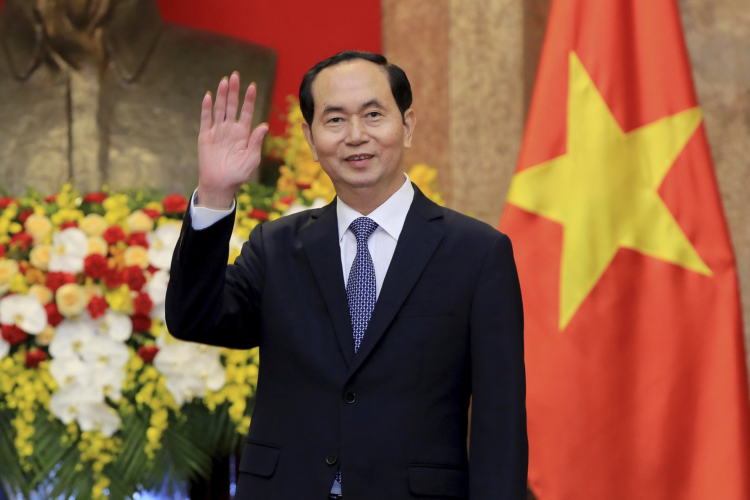 Vietnamese President Tran Dai Quang greets journalists as he waits for arrival of Russian Foreign Minister Sergei Lavrov at the Presidential Palace in Hanoi, Vietnam, March 23, 2018. Lavrov is on an official visit to Vietnam to promote bilateral cooperation between the two nations. (AP Photo/Minh Hoang, Pool)