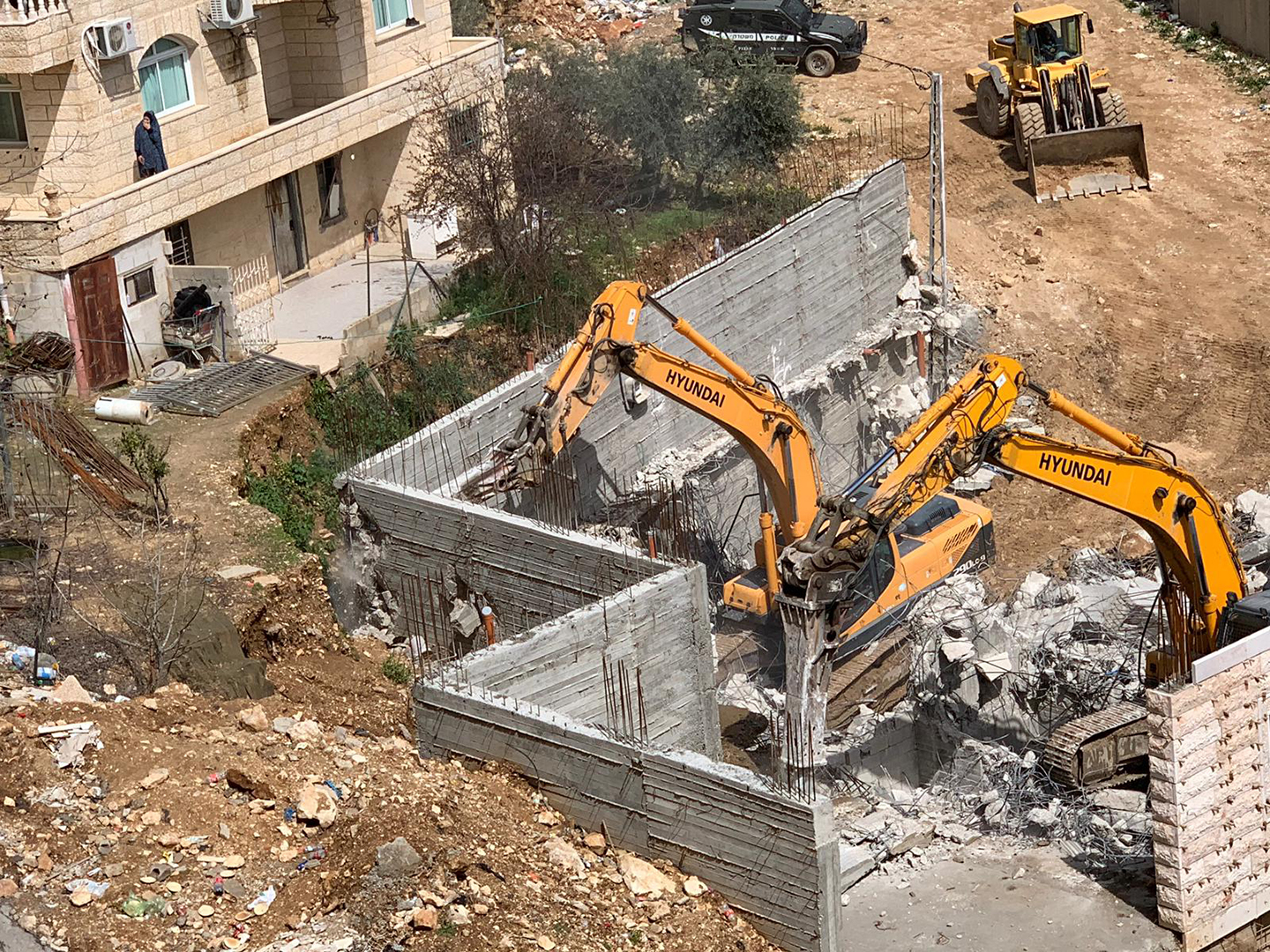 القدس - جرافات وآليات الاحتلال تهدم مبنى من طابقين بمخيم شعفاط-1