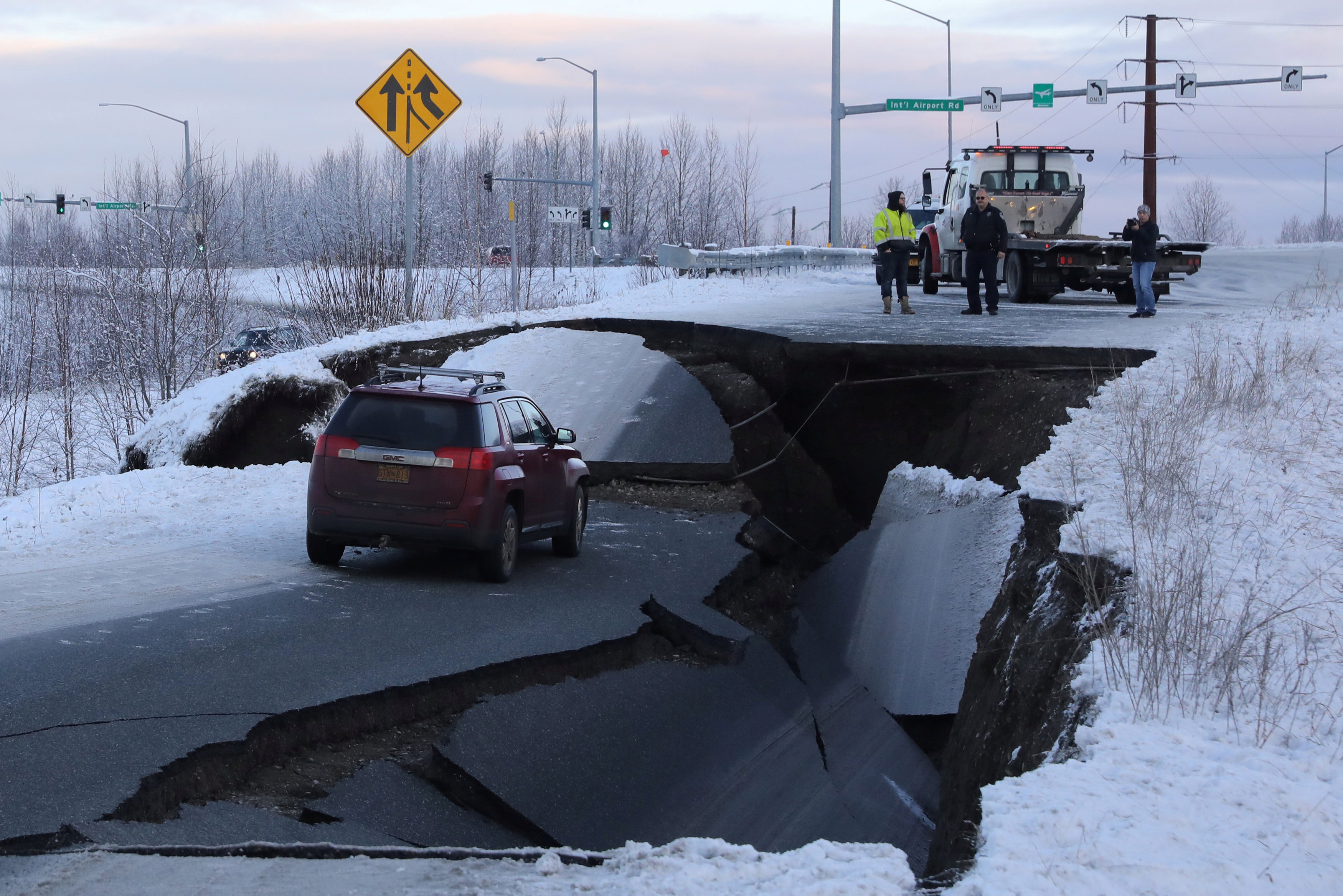 A stranded vehicle lies on a collapsed roadway near the airport after an earthquake in Anchorage, Alaska, U.S. November 30, 2018. REUTERS/Nathaniel Wilder