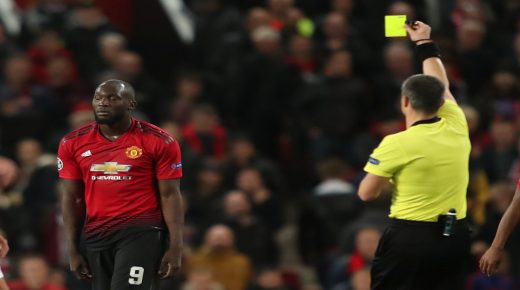 Soccer Football - Champions League - Group Stage - Group H - Manchester United v Valencia - Old Trafford, Manchester, Britain - October 2, 2018 Manchester United's Romelu Lukaku is shown a yellow card by referee Slavko Vincic Action Images via Reuters/Lee Smith
