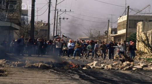 24 Feb 1988, Beit Ummar, West Bank --- Palestinian demonstrators throw stones at Israeli soldiers during a protest in the streets of Beit Omar. Violence broke out after rebel Israeli and Palestinian fighters protested in the disputed territory of West Bank during the first Intifada. | Location: Beit Omar, West Bank. --- Image by © Patrick Robert/Sygma/CORBIS
