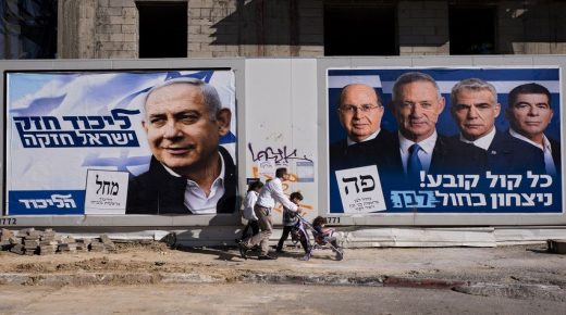 People walk by election campaign billboards showing Israeli Prime Minister and head of the Likud party Benjamin Netanyahu, left, alongside the Blue and White party leaders, from left to right, Moshe Yaalon, Benny Gantz, Yair Lapid and Gabi Ashkenazi, in Tel Aviv, Israel, Wednesday, April 3, 2019. Hebrew on billboards reads, left "Strong Likud strong Israel" on the right "Every vote matters, win Blue and White". (AP Photo/Oded Balilty)