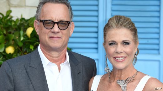 (FILES) In this file photo Tom Hanks and Rita Wilson pose on the red carpet upon arrival for the world premiere of the film "Mamma Mia! Here We Go Again" in London on July 16, 2018. - Tom Hanks and his wife Rita Wilson have both tested positive for coronavirus, the US actor said Wednesday. Hanks, 63, said he and Wilson came down with a fever while in Australia, and will now be isolated and monitored. (Photo by Anthony HARVEY / AFP)