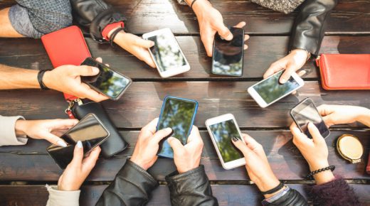 People group having addicted fun together using smartphones - Detail of hands sharing content on social network with mobile smart phones - Technology concept with millennials online with cellphones