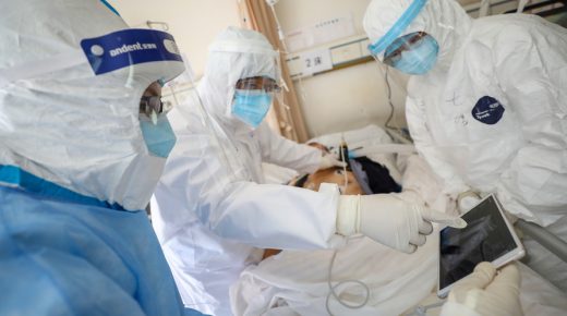 Medical workers in protective suits attend to a patient inside an isolated ward of Wuhan Red Cross Hospital in Wuhan, the epicentre of the novel coronavirus outbreak, in Hubei province, China February 16, 2020. Picture taken February 16, 2020. China Daily via REUTERS ATTENTION EDITORS - THIS IMAGE WAS PROVIDED BY A THIRD PARTY. CHINA OUT.