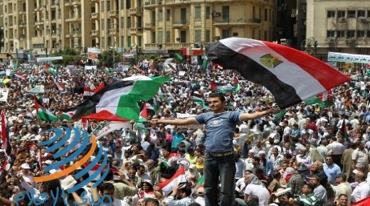 An Egyptian demonstrator waves Egyptian (R) and Palestinian flags as thousands gather at Cairo's Tahrir Square on May 13, 2011 during a protest calling for national unity after attacks on Egyptian churches, and solidarity with the Palestinians as they mark the "Nakba" or "catastrophe" which befell them following Israel's establishment in 1948. AFP PHOTO / KHALED DESOUKI (Photo credit should read KHALED DESOUKI/AFP/Getty Images) (Newscom TagID: afplivethree889040) [Photo via Newscom]