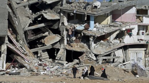 TOPSHOTS
A Palestinian family walks on August 27, 2014 past the collapsed remains of a building that was destroyed in fighting between Hamas militants and Israel during 50 days of fighting in Shejaiya. Israel and Palestinians both boasted of victory in the Gaza war but analysts say Hamas received only promises while the conflict aggravated divisions in the Israeli leadership. AFP PHOTO/ROBERTO SCHMIDT