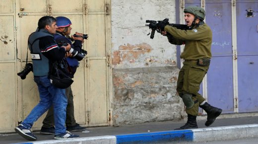 An Israeli soldier shouts as he aims his weapon during clashes with Palestinian demonstrators at a protest against U.S. President Donald Trump's decision to recognise Jerusalem as the capital of Israel, in the West Bank city of Hebron December 15, 2017. REUTERS/Mussa Qawasma