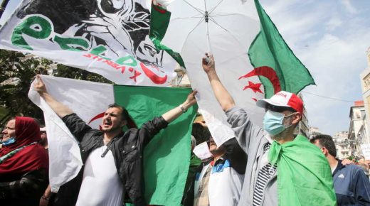 A demonstrator holds a national flag during a protest demanding political change, in Algiers, Algeria April 2, 2021. REUTERS/Ramzi Boudina