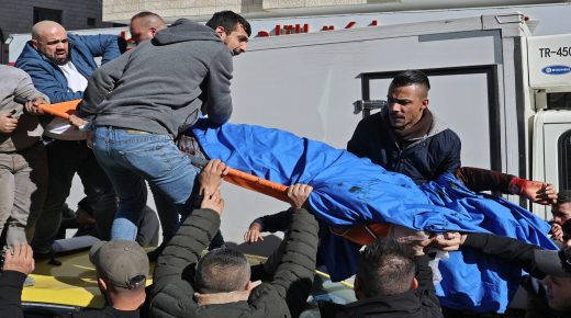 Palestinians carry the body of a man, one of three killed by Israeli froces in the occupied West Bank city of Nablus, on February 8, 2022. Three Palestinians were killed by Israeli forces in the occupied West Bank city of Nablus today during what Israel described as an operation against a "terrorist cell". (Photo by JAAFAR ASHTIYEH / AFP)