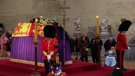 Members of the public pay their respects as they pass the coffin of Queen Elizabeth II, Lying in State inside Westminster Hall, at the Palace of Westminster in London on September 18, 2022. Britain was gearing up Sunday for the momentous state funeral of Queen Elizabeth II as King Charles III prepared to host world leaders and as mourners queued for the final 24 hours left to view her coffin, lying in state in Westminster Hall at the Palace of Westminster. (Photo by Adrian DENNIS / various sources / AFP)