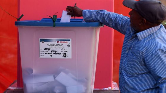 A voter casts his ballot in the general election at a polling station in Bhaktapur on the outskirts of Kathmandu on November 20, 2022. (Photo by PRAKASH MATHEMA / AFP)