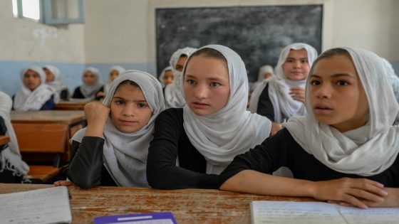 Afghan girls attend a class in a school in Kandahar on September 26, 2021. (Photo by BULENT KILIC / AFP)