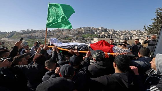 Mourners carry the body of Palestinian youth Yusef Muhaisen, killed by Israeli fire amid clashes, during his funeral in the West Bank town of Al-Ram on January 27, 2023. (Photo by AHMAD GHARABLI / AFP)