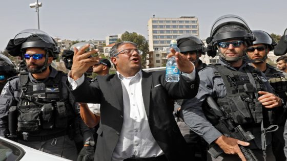 Israeli riot policemen surround Knesset member and head of the far right Jewish Power (Otzma Yehudit) party Itamar Ben-Gvir in the Sheikh Jarrah neighbourhood of the Israeli-annexed east Jerusalem on May 10, 2021. - More than 300 people were wounded in renewed confrontations between Palestinians and Israeli police at the Al-Aqsa mosque compound, as an Israeli celebration of its 1967 takeover of Jerusalem risked inflaming tensions. The violence since May 7 has been Jerusalem's worst since 2017, fuelled by a long-running bid by Jewish settlers to evict several Palestinian families from their nearby east Jerusalem Sheikh Jarrah neighbourhood. (Photo by Gil COHEN-MAGEN / AFP)