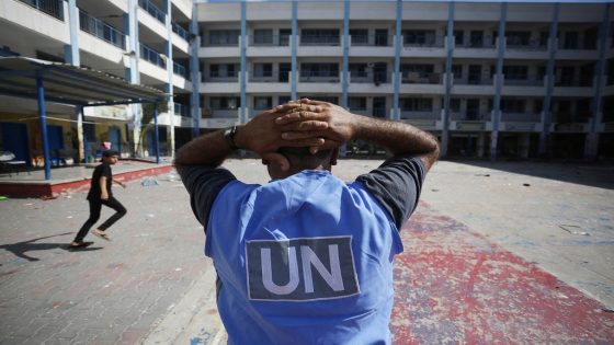 A United nations volunteer stands in the yard of a UN-run school in the refugee camp of Al-Maghazi in the central Gaza Strip, a day after at least 6 people were killed in a reported Israeli strike, on October 18, 2023. - Dozens of people, including UNRWA staff, were wounded and the school suffered severe structural damage, the United Nations agency for Palestinian refugees said. (Photo by Mohammed Faiq / AFP)