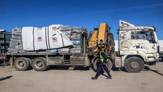 A man walks past a truck carrying humanitarian aid from the UK that entered Gaza by truck through the Kerem Shalom (Karm Abu Salem) border crossing in the southern part of the Palestinian territory on February 17, 2024, in Rafah on the southern Gaza Strip, amid the ongoing conflict between Israel and the Palestinian militant group Hamas. (Photo by SAID KHATIB / AFP) (Photo by SAID KHATIB/AFP via Getty Images)