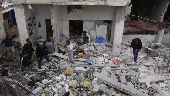 Palestinians inspect the site where medics said an interceptor missile fell and destroyed several houses, injuring over a dozen, in the Israeli-occupied West Bank Tulkarem refugee camp, Monday, Nov. 25, 2024. (AP Photo/Majdi Mohammed)