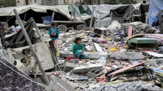 A girl sits by the rubble outside the Sabah family building that was hit by Israeli air strikes in Deir el-Balah in the central Gaza Strip on April 8, 2025. Israel's military resumed its offensive in Gaza on March 18, and since then, more than 1,330 people have been killed in the territory, according to the Hamas-run territory's health ministry. (Photo by Eyad BABA / AFP)