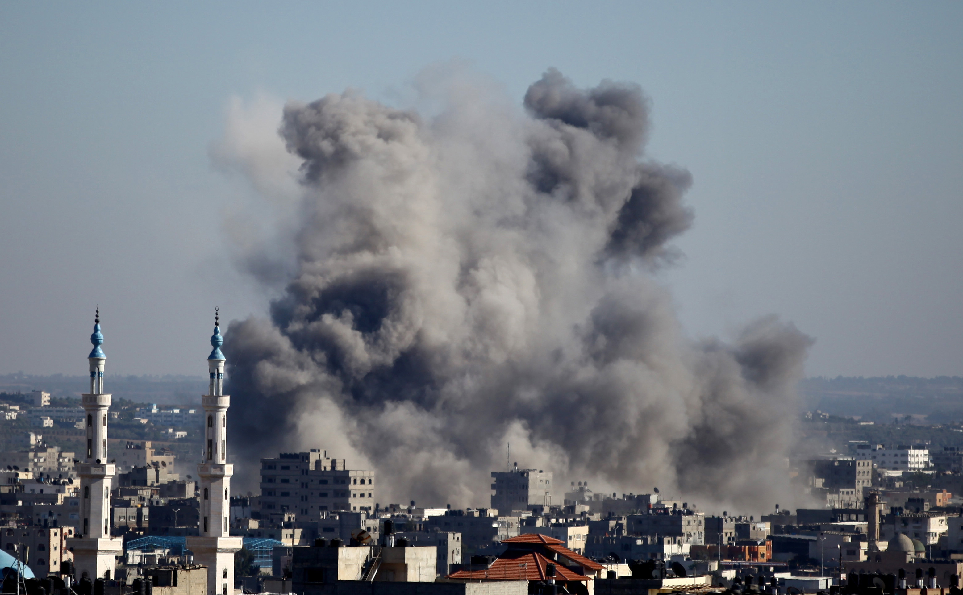 Smoke billows from buildings following an Israeli air strike in Gaza City on July 11, 2014. Israel's aerial bombardment of Gaza claimed its 105th Palestinian life as Hamas pounded central Israel with rockets and Washington offered to help broker a truce. AFP PHOTO/MOHAMMED OTHMAN