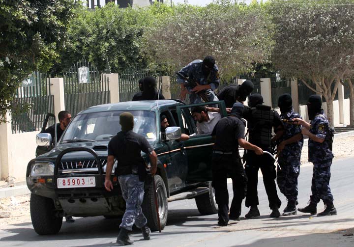 Members of the Hamas Executive Force arrest a Palestinian Fatah party supporter as he and others tried to attend Friday noon prayers out side the Nusseirat refugee camp in the central Gaza Strip, 07 September 2007. Hamas police wounded 11 Palestinians as they broke up crowds gathering to pray outdoors across the Gaza Strip on Friday in defiance of an Islamist ban on such gatherings, medics and witnesses said