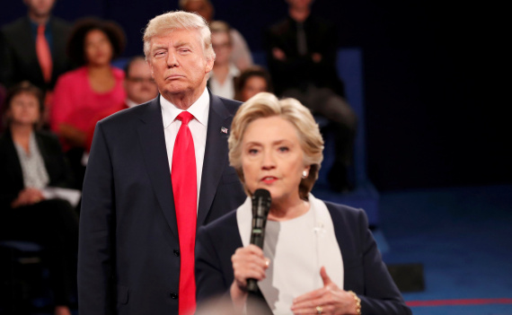 Republican U.S. presidential nominee Donald Trump listens as Democratic nominee Hillary Clinton answers a question from the audience during their presidential town hall debate at Washington University in St. Louis, Missouri, U.S., October 9, 2016. REUTERS/Rick Wilking TPX IMAGES OF THE DAY