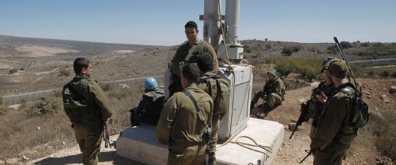 Israeli soldiers and peacekeepers of the United Nations Disengagement Observer Force (UNDOF) (2nd from L) monitor the border with Syria near the village of Majdal Shams in the Israeli-occupied sector of the Golan Heights on September 13, 2016.
Israel's military denied a Syrian claim that it had shot down two Israeli military aircraft. The Israeli army earlier said it targeted Syrian army positions after stray fire from its war-torn neighbour hit the Israeli-held zone of the Golan Heights on September 12. / AFP / JALAA MAREY (Photo credit should read JALAA MAREY/AFP/Getty Images)
