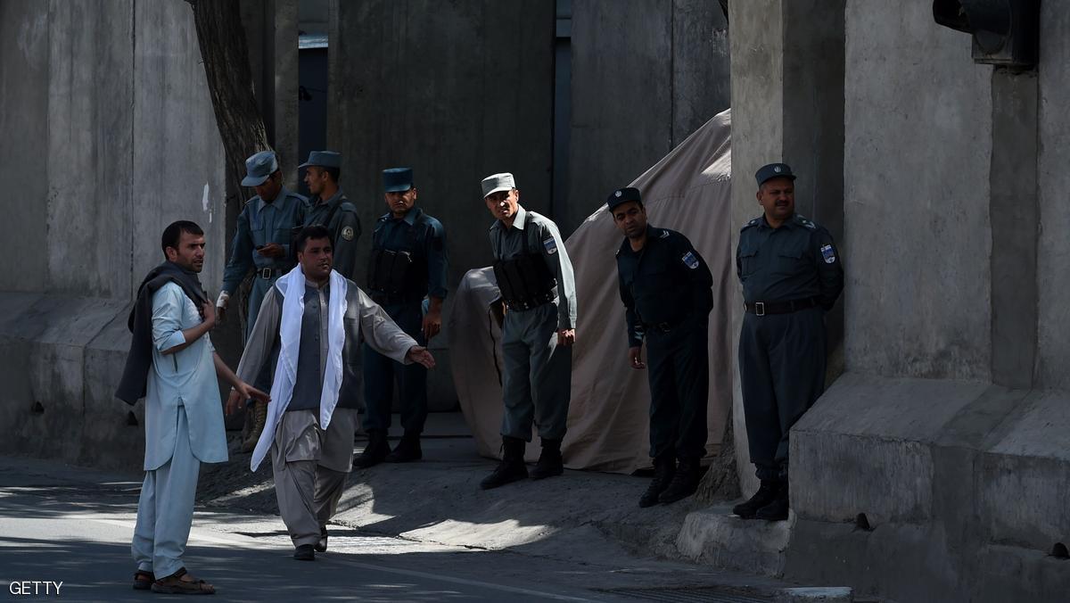 Afghan policemen look on as unseen supporters carry coffins containing the remains of Afghan King Habibullah Kalakani and comrades during a funeral ceremony at the city in Kabul on September 1, 2016. Clashes erupted in the Afghan capital as supporters of an ancient monarch derided as a "bandit king" sought to rebury his remains, laying bare the country's deep-rooted ethnic divisions. / AFP / WAKIL KOHSAR (Photo credit should read WAKIL KOHSAR/AFP/Getty Images)