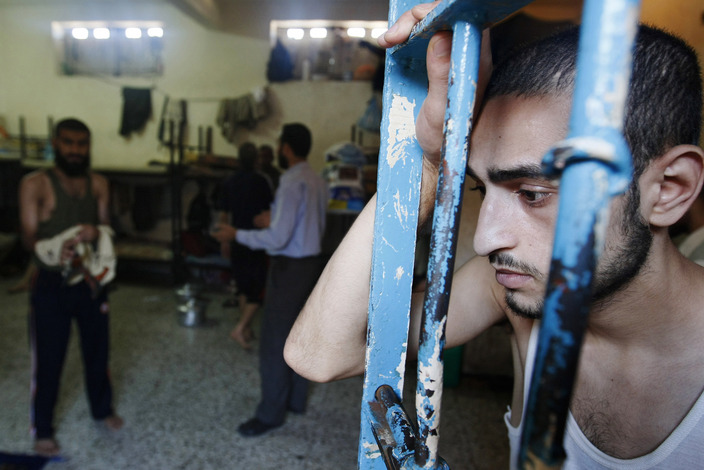 Palestinian inmates stand in a cell at the new prison controlled by the Hamas police in Gaza City on August 6, 2009. The detention facility was opened after Gaza's main prison was destroyed during Israels 22-day military offensive last winter. According to Hamas police, 350 prisoners accused of spying for the Israeli intelligence and a number of other defendants in the transfer of information to the Palestinian Authority in Ramallah and other criminal charges and drug trafficking are jailed in the Gaza Strip. AFP PHOTO/MOHAMMED ABED (Photo credit should read MOHAMMED ABED/AFP/Getty Images)