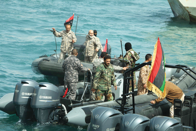 epa04136814 Members of Libya's naval coastguard man speed boats as they wait for the arrival of the Morning Glory, an oil tanker that US Navy handed over to Libyan authorities at Zawiya port in Zawiya, Libya, 22 March 2014. The United States had handed over to Libyan authorities a vessel seized after it was illegally loaded with crude oil at a terminal controlled by Libyan rebels, a Libyan official said on 22 March. EPA/SABRI ELMHEDWI