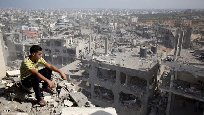 A Palestinian man looks out over destruction in part of Gaza City's al-Tufah neighbourhood as the fragile ceasefire in the Gaza Strip entered a second day on August 6, 2014 while Israeli and Palestinian delegations prepared for crunch talks in Cairo to try to extend the 72-hour truce. The ceasefire, which came into effect on August 5, has brought relief to both sides after one month of fighting killed 1,875 Palestinians and 67 people on the Israeli side. AFP PHOTO / MAHMUD HAMS (Photo credit should read MAHMUD HAMS/AFP/Getty Images)