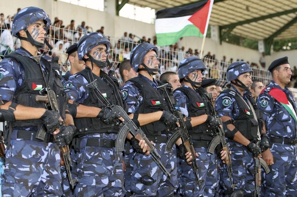 Members of the Palestinian security forces take part in a graduation ceremony in the West Bank town of Jericho June 15, 2009. REUTERS/Nayef Hashlamoun (WEST BANK POLITICS MILITARY)